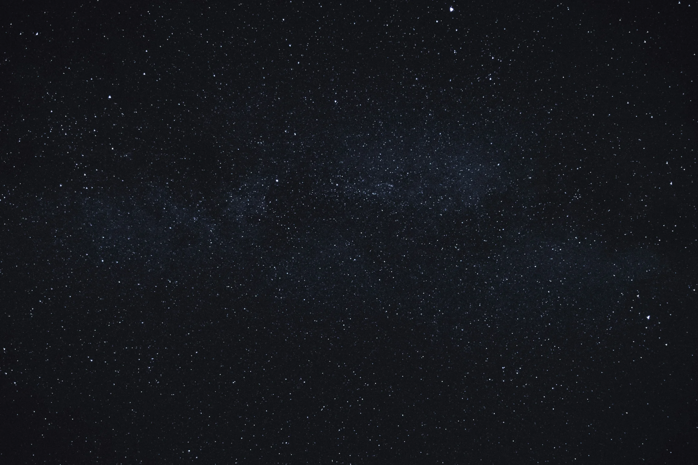 Dark night sky filled with countless tiny stars creating a star field pattern